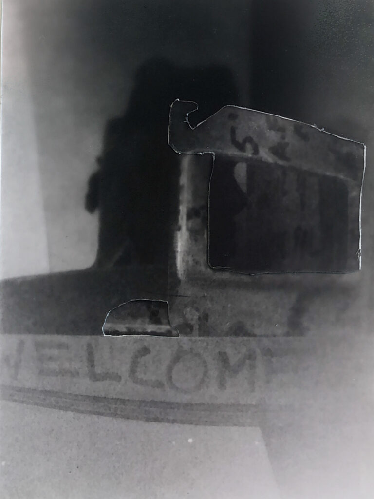 Pinhole shot welcome sign face