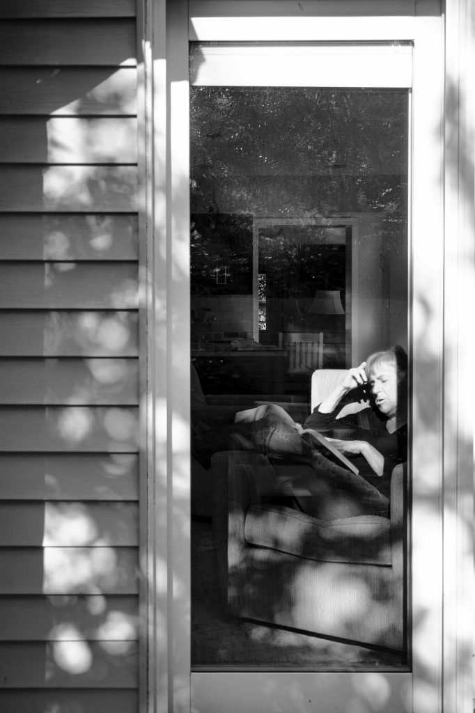 Person through a window reading