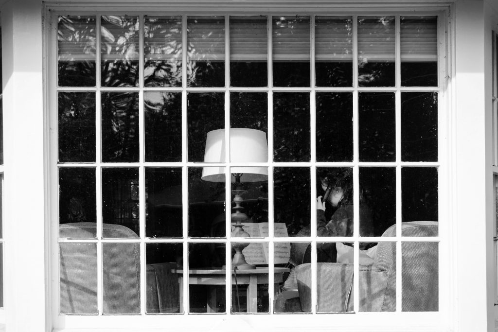 Girl practicing cello through window