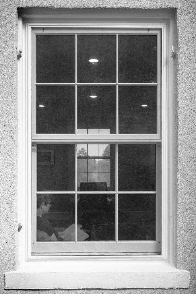 Woman reading through a window