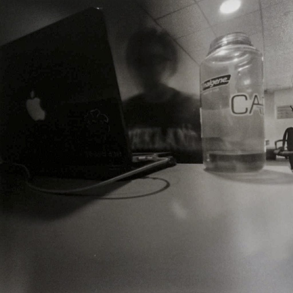 Long exposure of person with laptop and water bottle